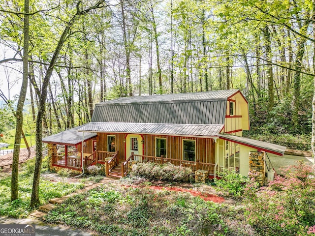 63 Eagle Chase Cir, Dillard, GA 30537 - view of front facade featuring a gambrel roof, covered porch, and a metal roof