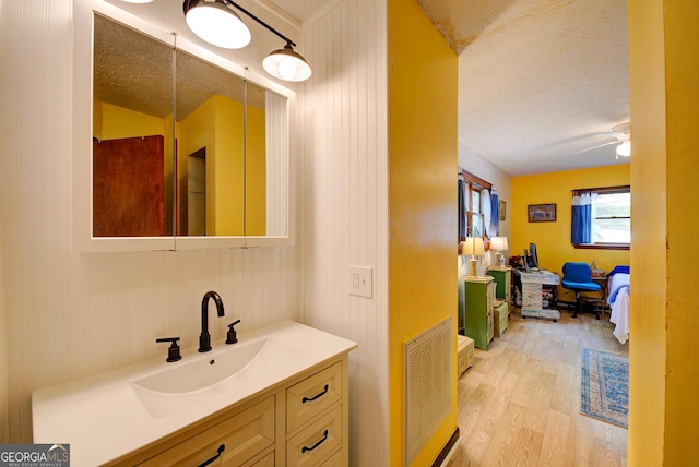 63 Eagle Chase Cir, Dillard, GA 30537 - bathroom with a textured ceiling, wood finished floors, visible vents, and vanity