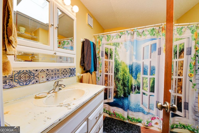 63 Eagle Chase Cir, Dillard, GA 30537 - bathroom with vanity, a textured ceiling, and vaulted ceiling