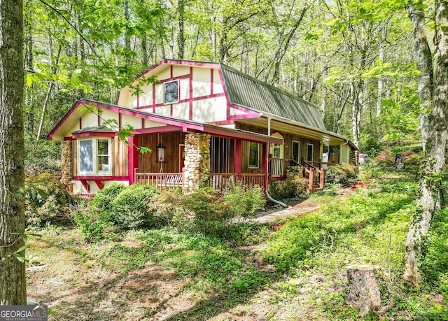 63 Eagle Chase Cir, Dillard, GA 30537 - view of front of house with a gambrel roof, covered porch, and metal roof