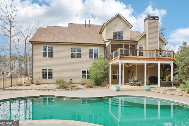 108 Turnberry Trce, Sharpsburg, GA 30277 - rear view of property featuring a ceiling fan, a sunroom, an outdoor pool, a patio, and a chimney