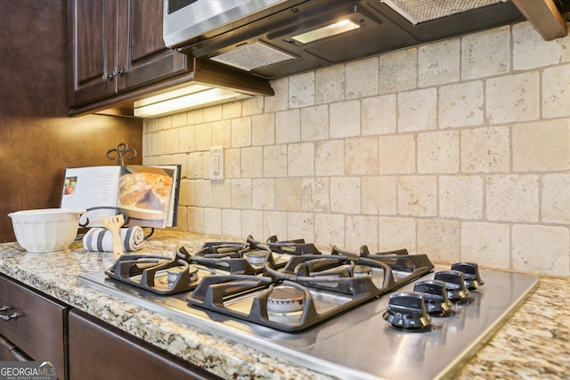 108 Turnberry Trce, Sharpsburg, GA 30277 - kitchen view of dark brown cabinetry, stainless steel gas stovetop, and light stone counters
