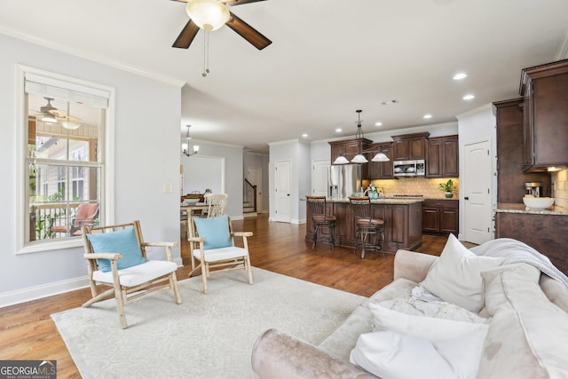 108 Turnberry Trce, Sharpsburg, GA 30277 - living area with a ceiling fan, crown molding, stairs, recessed lighting, and wood finished floors
