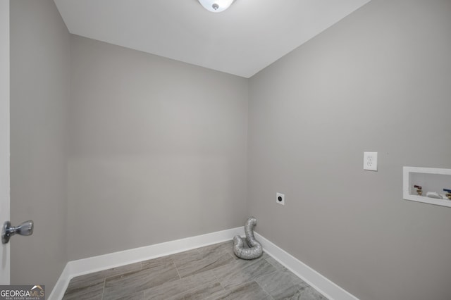 clothes washing area featuring hookup for an electric dryer, hookup for a washing machine, laundry area, and baseboards