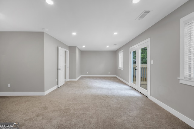 empty room featuring recessed lighting, visible vents, light carpet, and baseboards