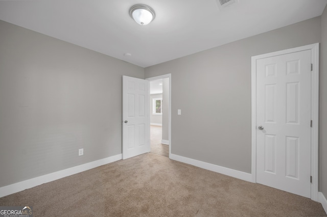 unfurnished bedroom featuring carpet flooring and baseboards