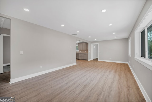 unfurnished living room featuring recessed lighting, visible vents, baseboards, and light wood-style floors