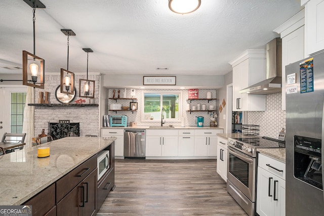 205 Tamea Trl, Covington, GA 30014 - kitchen featuring appliances with stainless steel finishes, wall chimney exhaust hood, open shelves, white cabinets, and a textured ceiling