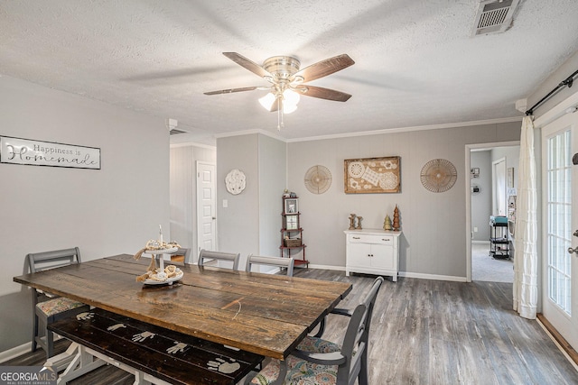 205 Tamea Trl, Covington, GA 30014 - dining area featuring wood finished floors, a ceiling fan, baseboards, a textured ceiling, and crown molding