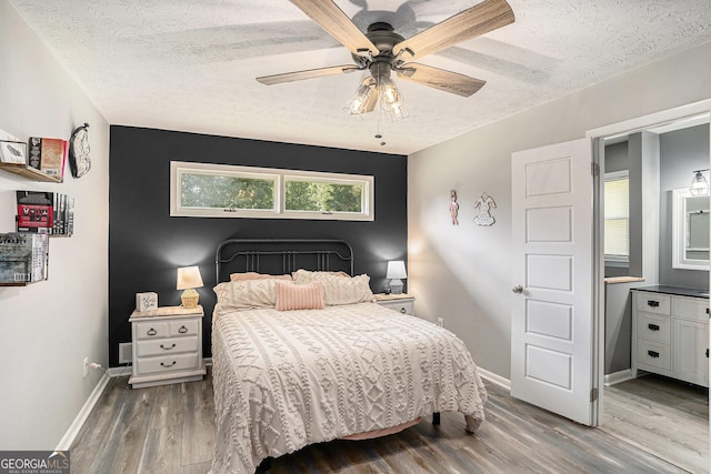 205 Tamea Trl, Covington, GA 30014 - bedroom with a textured ceiling, wood finished floors, baseboards, and ceiling fan