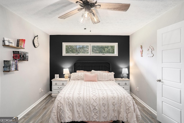 205 Tamea Trl, Covington, GA 30014 - bedroom featuring a textured ceiling, baseboards, wood finished floors, and ceiling fan