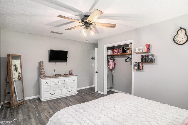 205 Tamea Trl, Covington, GA 30014 - bedroom featuring dark wood-style floors, a closet, baseboards, ceiling fan, and a textured ceiling