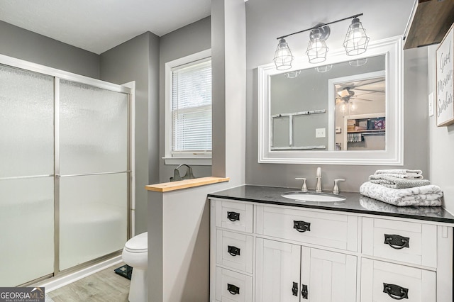 205 Tamea Trl, Covington, GA 30014 - full bath featuring ceiling fan, a stall shower, vanity, wood finished floors, and toilet