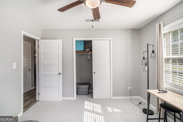 205 Tamea Trl, Covington, GA 30014 - bedroom with a closet, carpet flooring, baseboards, a textured ceiling, and ceiling fan