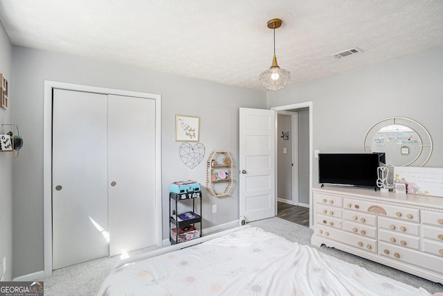 205 Tamea Trl, Covington, GA 30014 - bedroom featuring baseboards, carpet, a closet, and a textured ceiling
