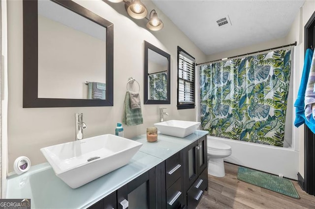 255 Deer Run Rd, Ellenwood, GA 30294 - bathroom featuring toilet, a sink, shower / bath combo, and wood finished floors