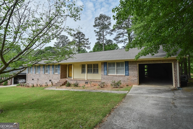ranch-style house featuring brick siding, aphalt driveway, a front lawn, and an attached garage