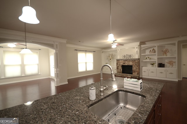 1142 Terrasol Rdg SW, Lilburn, GA 30047 - kitchen with ornamental molding, a sink, dark wood-type flooring, a fireplace, and ceiling fan