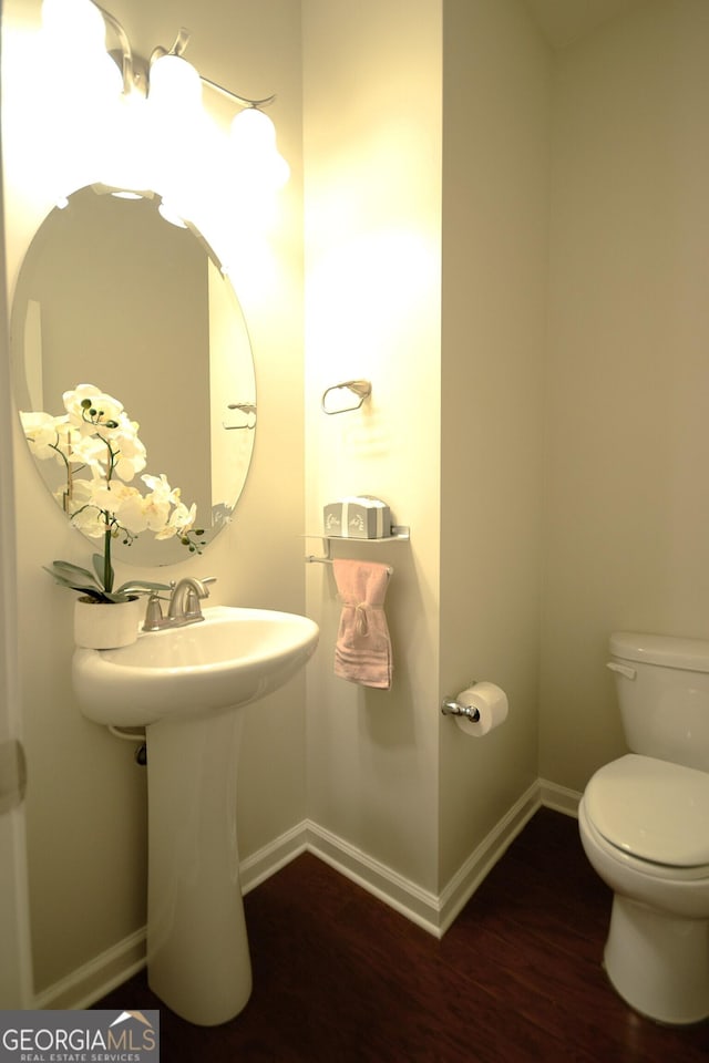 1142 Terrasol Rdg SW, Lilburn, GA 30047 - bathroom featuring baseboards, wood finished floors, and toilet