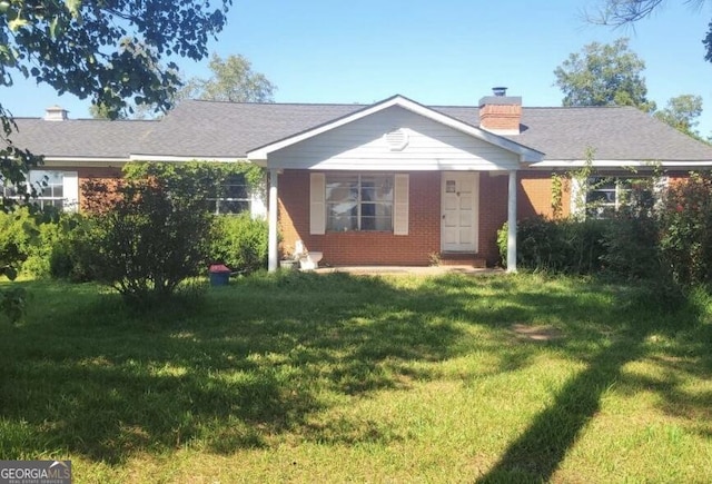 745 Harmony Church Rd, Colquitt, GA 39837 - ranch-style house featuring a front yard, a chimney, and brick siding