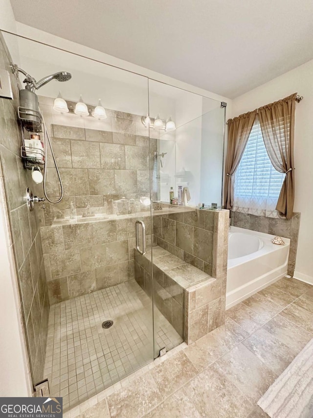 bathroom featuring a stall shower and a garden tub