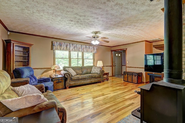 171 Wynn Dr, Hampton, GA 30228 - living room with a ceiling fan, wood finished floors, a wood stove, and ornamental molding