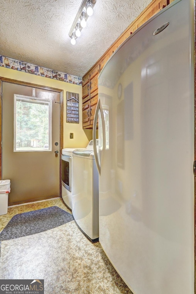 171 Wynn Dr, Hampton, GA 30228 - washroom with laundry area, washer and clothes dryer, a textured ceiling, and carpet