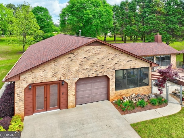171 Wynn Dr, Hampton, GA 30228 - view of front of home featuring a garage, driveway, french doors, and brick siding