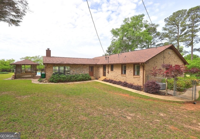 171 Wynn Dr, Hampton, GA 30228 - single story home with a gazebo, central AC, a front lawn, brick siding, and a chimney