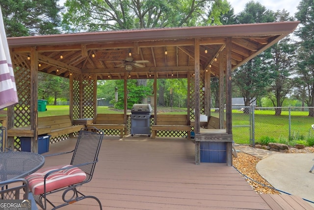 171 Wynn Dr, Hampton, GA 30228 - wooden deck with grilling area, ceiling fan, a gazebo, fence, and a yard