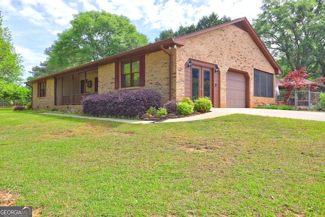 171 Wynn Dr, Hampton, GA 30228 - view of front of home with fence, brick siding, a garage, a front yard, and driveway