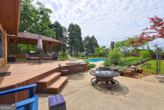 171 Wynn Dr, Hampton, GA 30228 - view of patio featuring outdoor dining area, a wooden deck, fence, a fenced in pool, and a fire pit