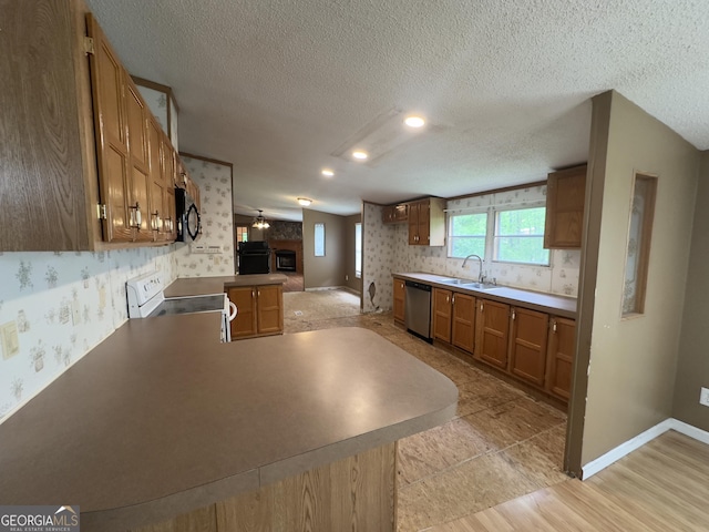 492 Garmon Rd, Cedartown, GA 30125 - kitchen featuring a sink, white range with electric cooktop, wallpapered walls, stainless steel dishwasher, and black microwave