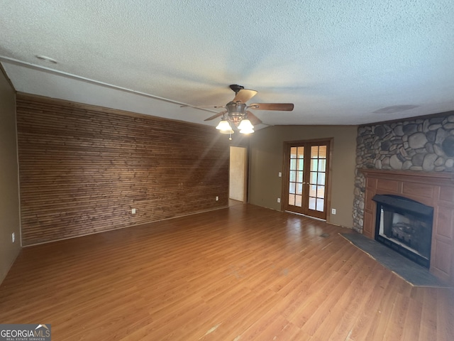 492 Garmon Rd, Cedartown, GA 30125 - unfurnished living room with a fireplace, a textured ceiling, a ceiling fan, and wood finished floors