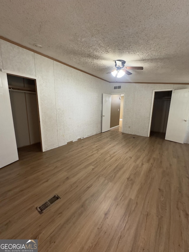 492 Garmon Rd, Cedartown, GA 30125 - unfurnished bedroom with a textured ceiling, visible vents, and wood finished floors