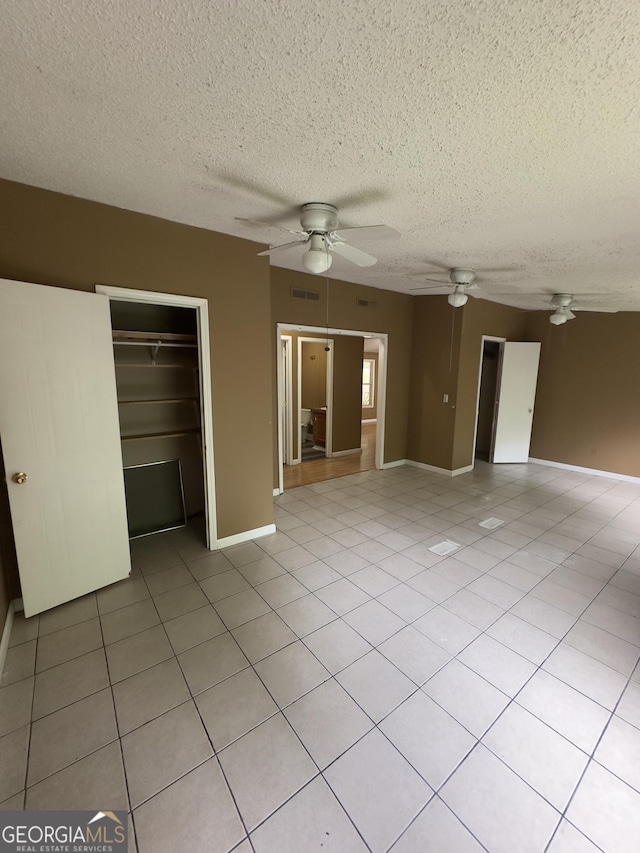 492 Garmon Rd, Cedartown, GA 30125 - interior space with light tile patterned floors, a ceiling fan, a textured ceiling, visible vents, and baseboards