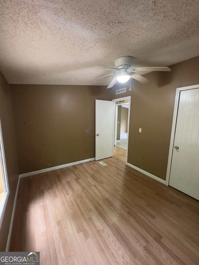 492 Garmon Rd, Cedartown, GA 30125 - empty room featuring a ceiling fan, visible vents, light wood-type flooring, and a textured ceiling