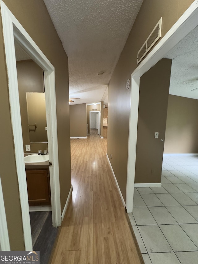 492 Garmon Rd, Cedartown, GA 30125 - hallway featuring baseboards, a sink, visible vents, and a textured ceiling