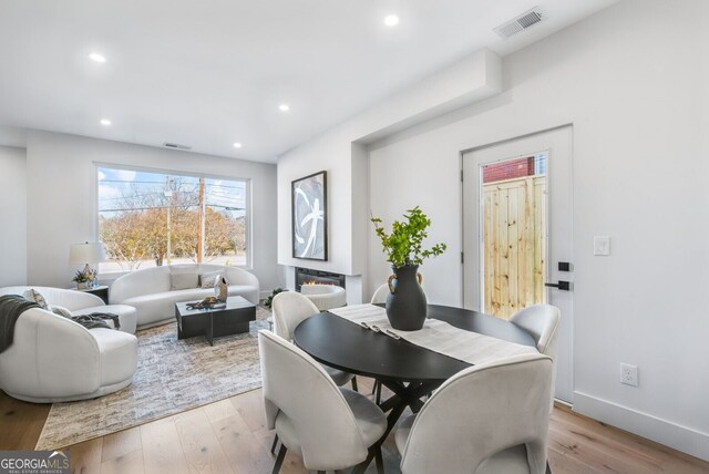 dining room with light wood-style floors, recessed lighting, and visible vents
