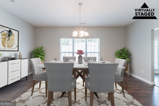 dining space featuring baseboards, a notable chandelier, a healthy amount of sunlight, and dark wood-style floors