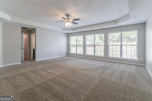 empty room featuring a textured ceiling, baseboards, and ceiling fan