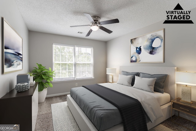 bedroom with a textured ceiling, visible vents, ceiling fan, carpet flooring, and baseboards