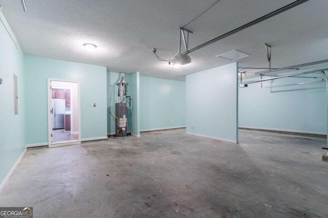 garage featuring water heater, refrigerator with ice dispenser, baseboards, and a garage door opener