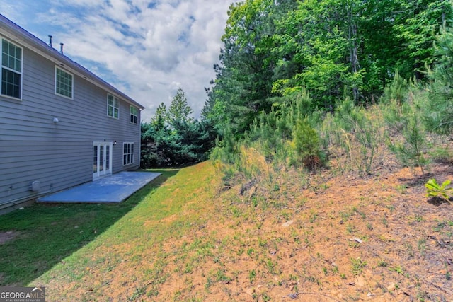 view of yard with a patio area and french doors