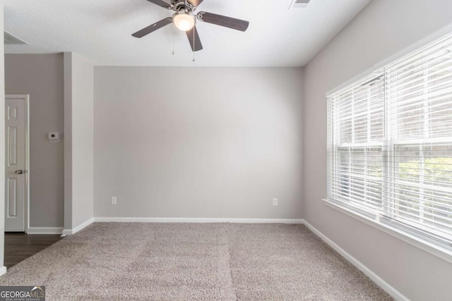 unfurnished room featuring a ceiling fan, baseboards, and carpet floors