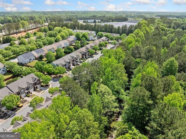 drone / aerial view with a residential view and a wooded view