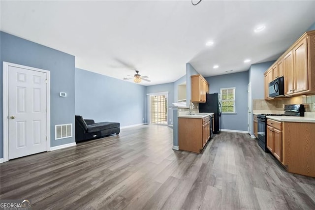 3366 Thornbridge Dr, Powder Springs, GA 30127 - kitchen with visible vents, open floor plan, wood finished floors, and black appliances