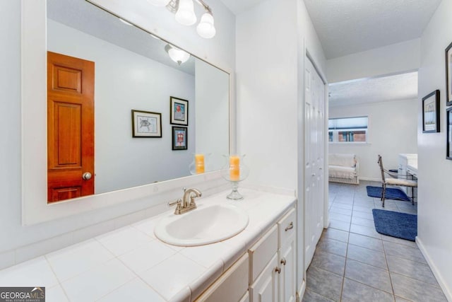 417 Pulliam Ln, Royston, GA 30662 - bathroom with vanity, a textured ceiling, baseboards, tile patterned flooring, and ensuite bath