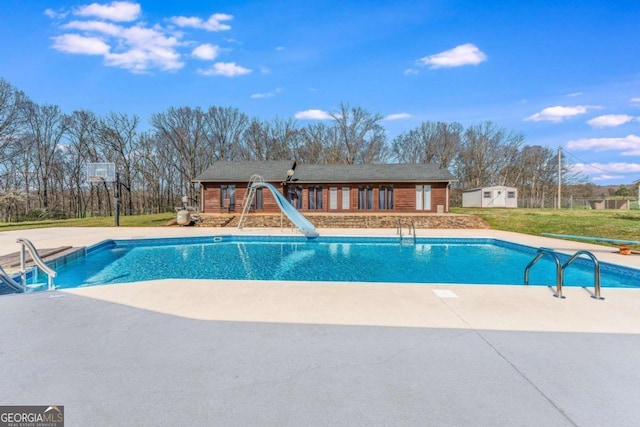 417 Pulliam Ln, Royston, GA 30662 - pool with a water slide, a yard, an outbuilding, and a patio area