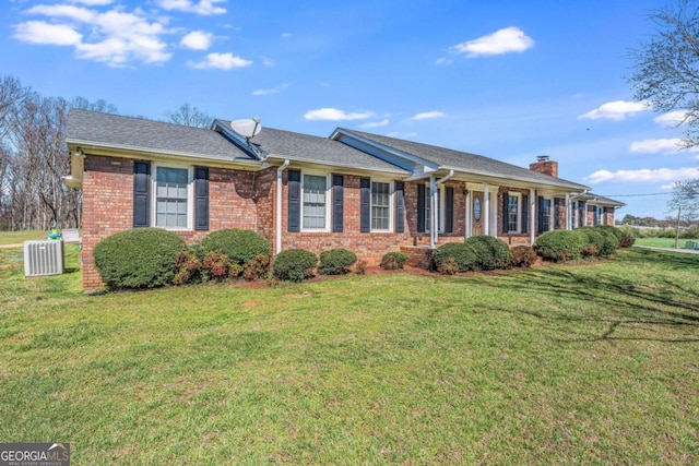 417 Pulliam Ln, Royston, GA 30662 - view of front of home with brick siding, a chimney, a front yard, and central AC unit